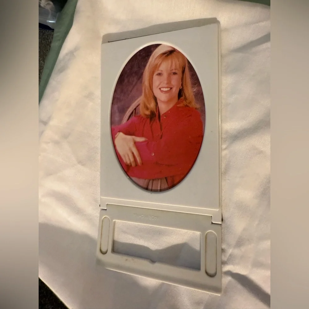 Folding Travel-style mirror - I believe it also hold a photo on the other side